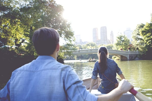 Couple rowing a boat in Central Park.