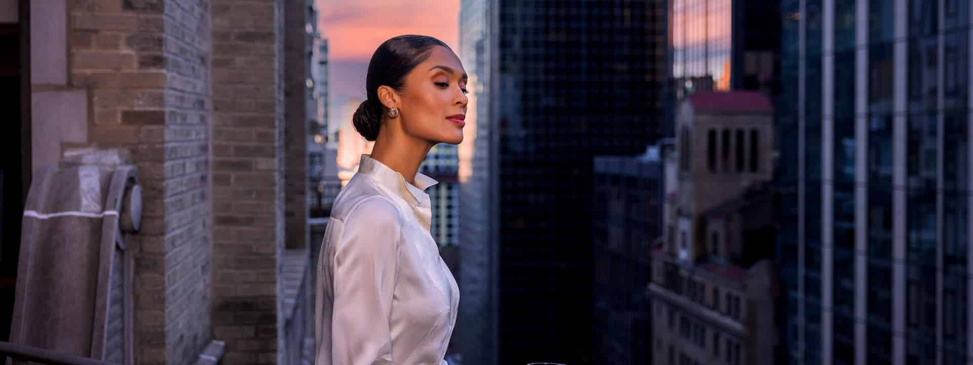 A person overlooking the New York downtown on the balcony.