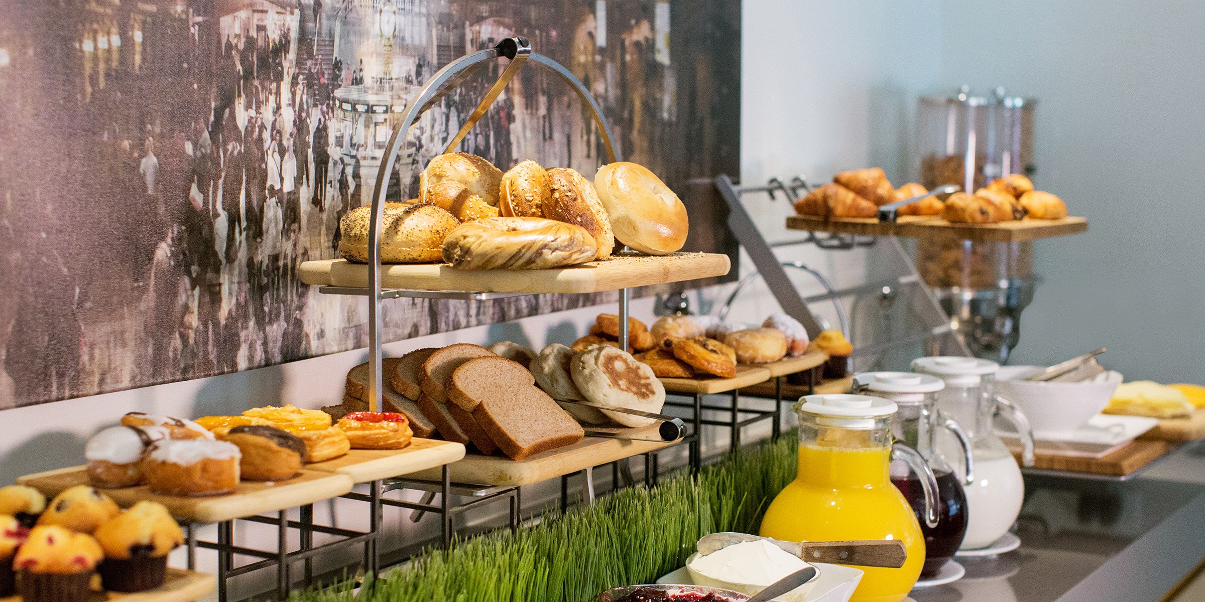 Breakfast buffet with pastries, juice, and coffee.