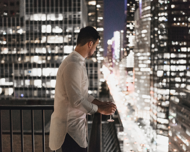 A person overlooking the downtown traffic.