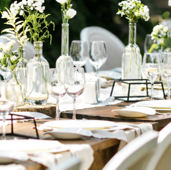 Rustic wedding table with floral centerpieces and candles.