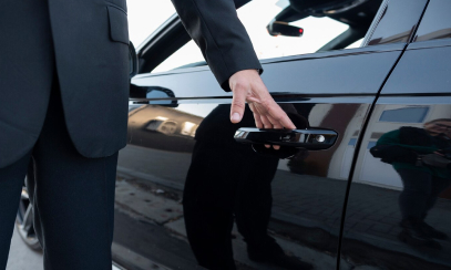 A chauffeur opening car door.