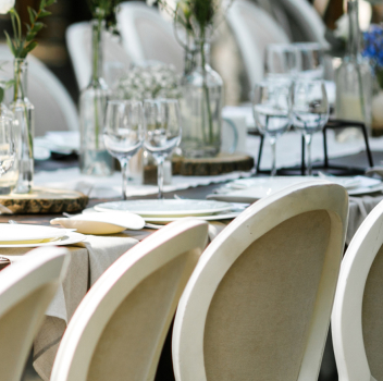 Close-up of a beautifully set outdoor event table.