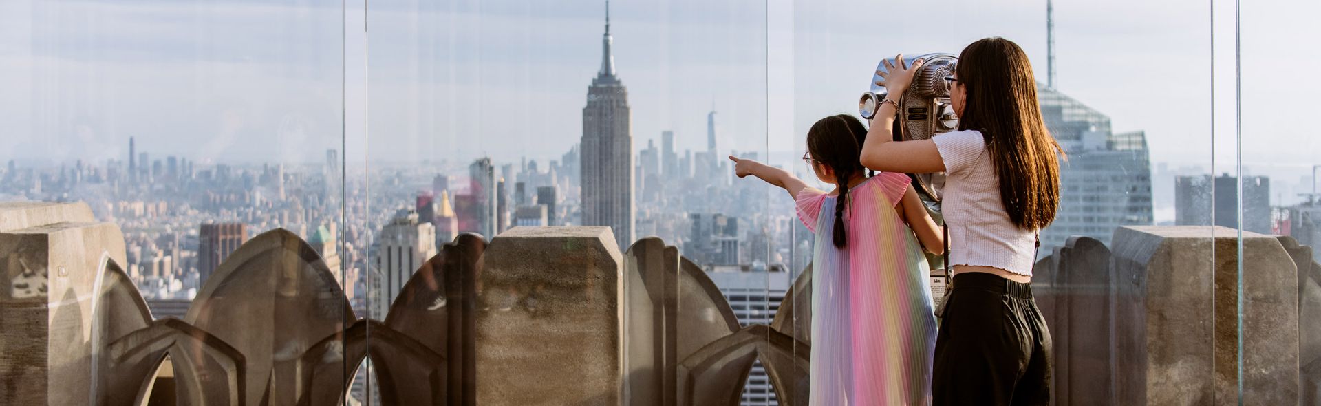 Two girls enjoying NYC skyline view.