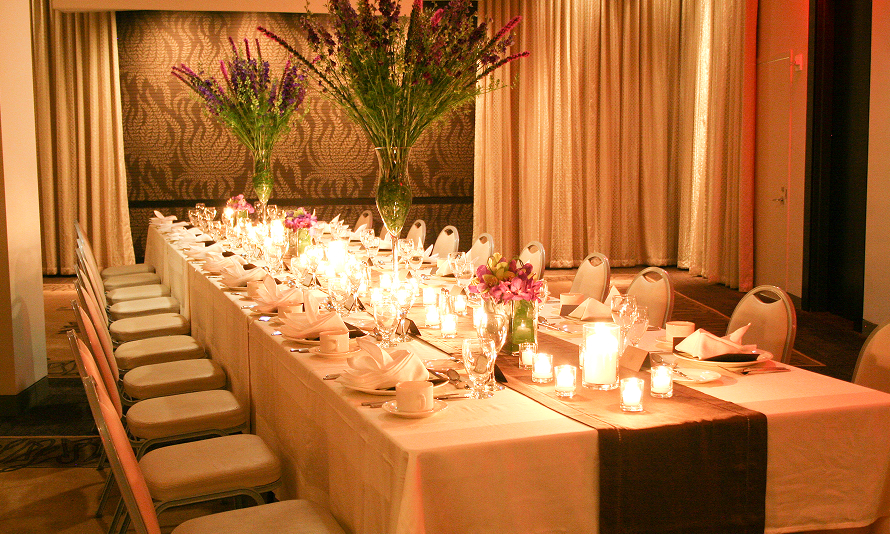 Romantic banquet hall with floral and candlelit decor.