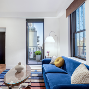 Hotel guest room living space with a modern sofa bed.