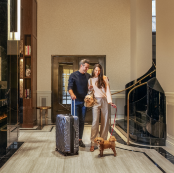 Lovely couple with a dog in the hotel lobby.