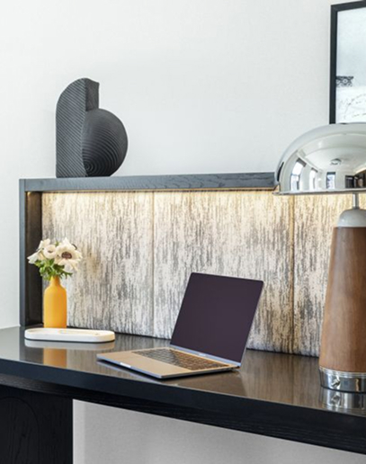 A lap top on a work desk in a hotel room.