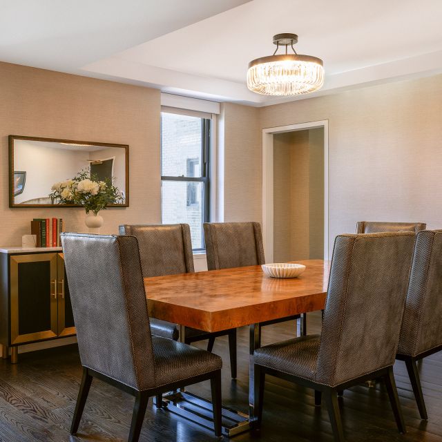 Room with a rectangular table fitting seven chairs.