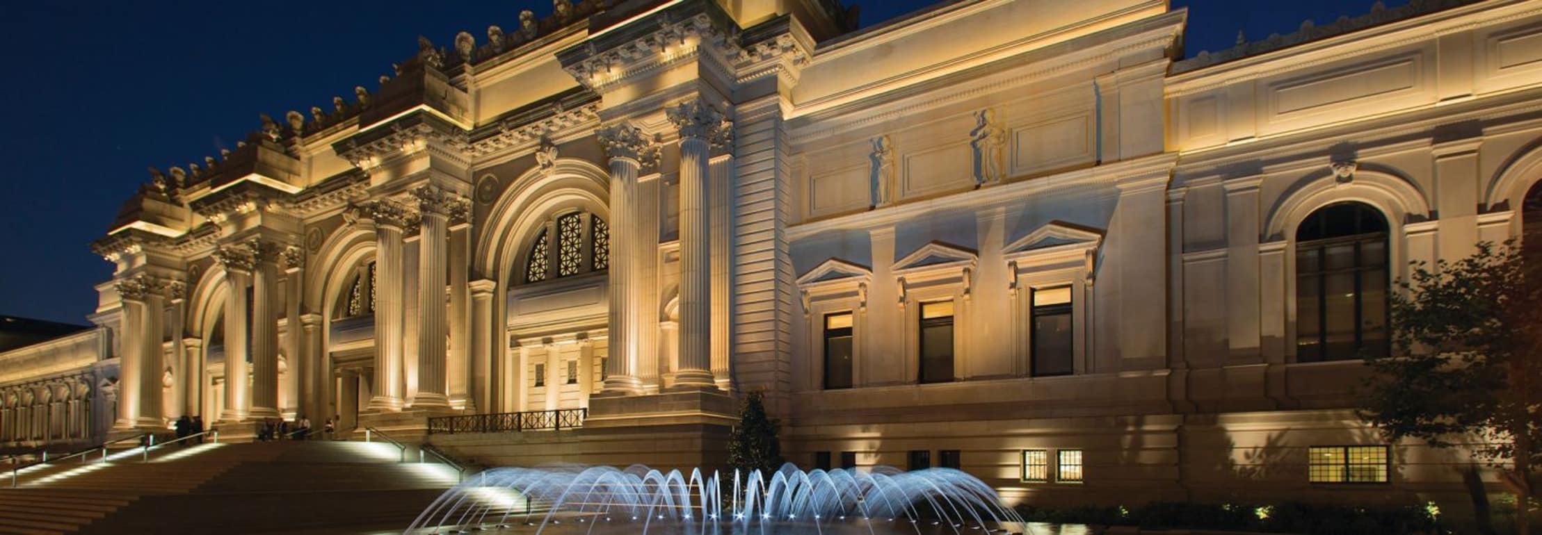 Exterior view of the Metropolitan Museum of Art, featuring its impressive façade and steps leading to the entrance.